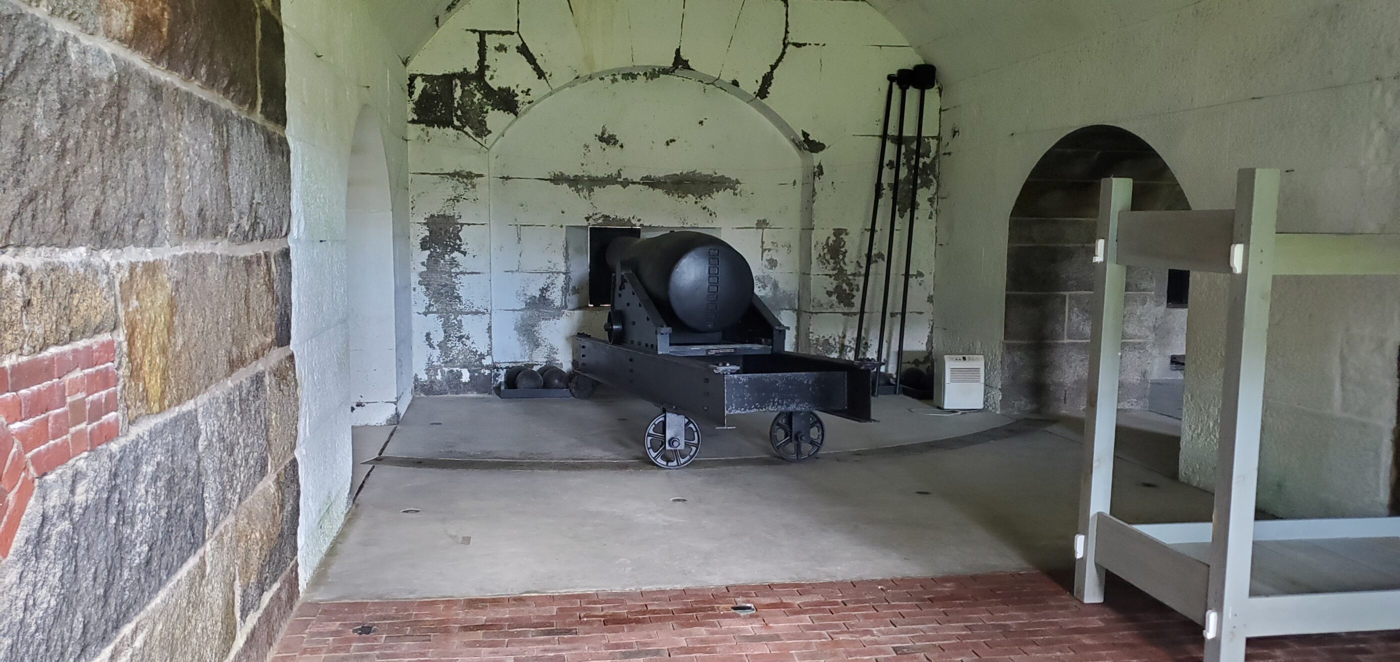 Cannon with assorted tools and door opening towards the harbor.