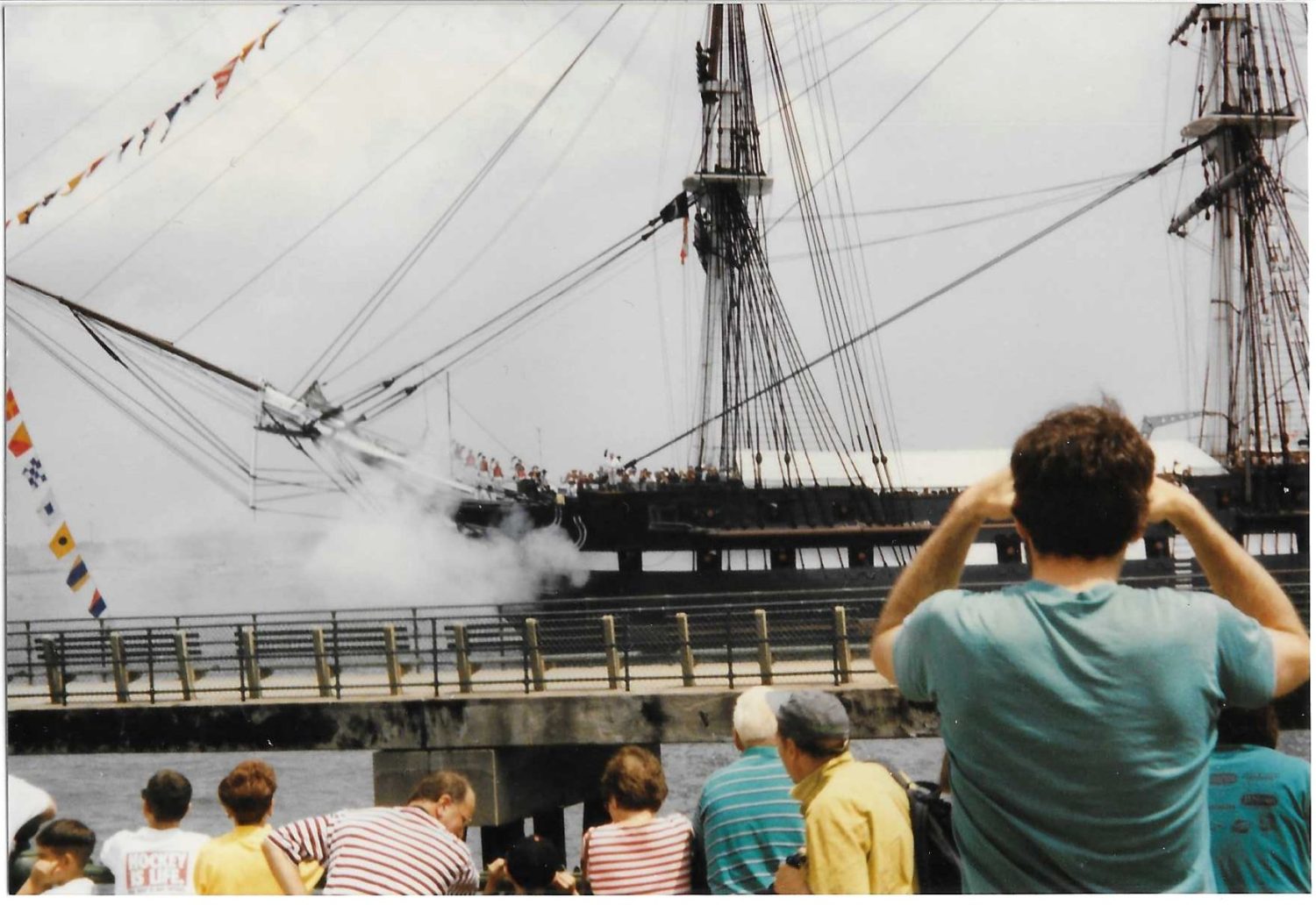 USS Constitution salute going past fishing pier